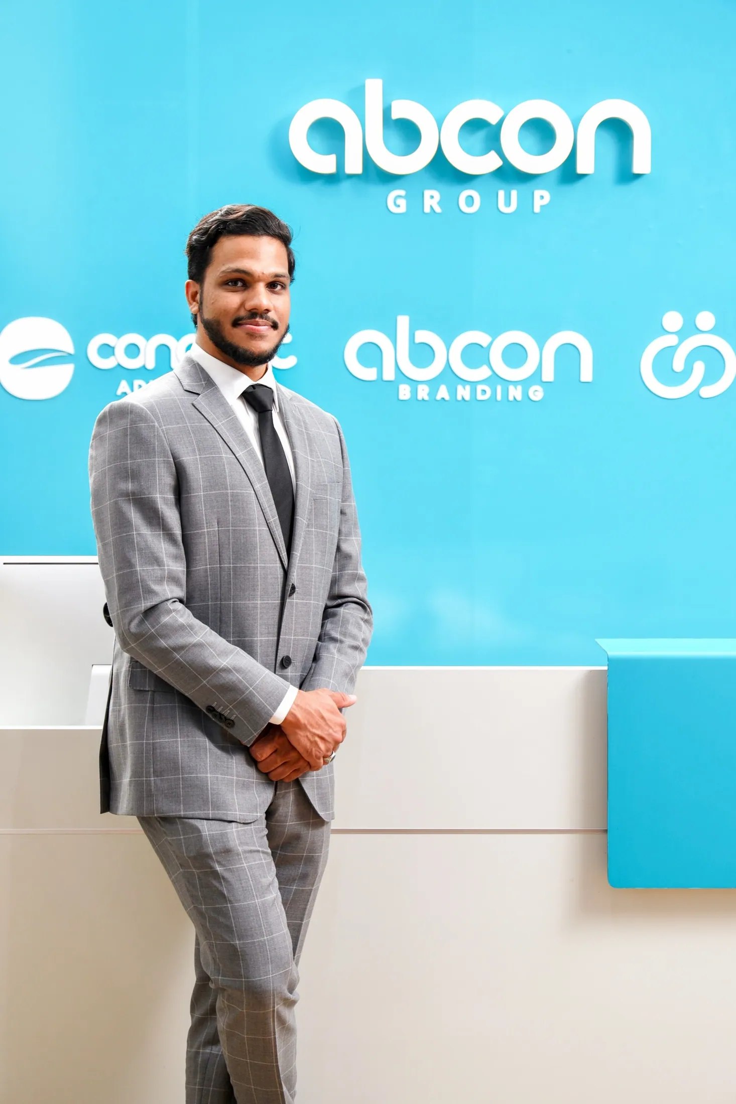 Muhammed Shafad in a grey suit at the Abcon Branding office